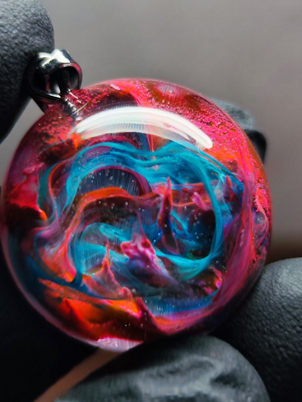 Magic jewelry space hearts made of epoxy resin and alcohol ink.