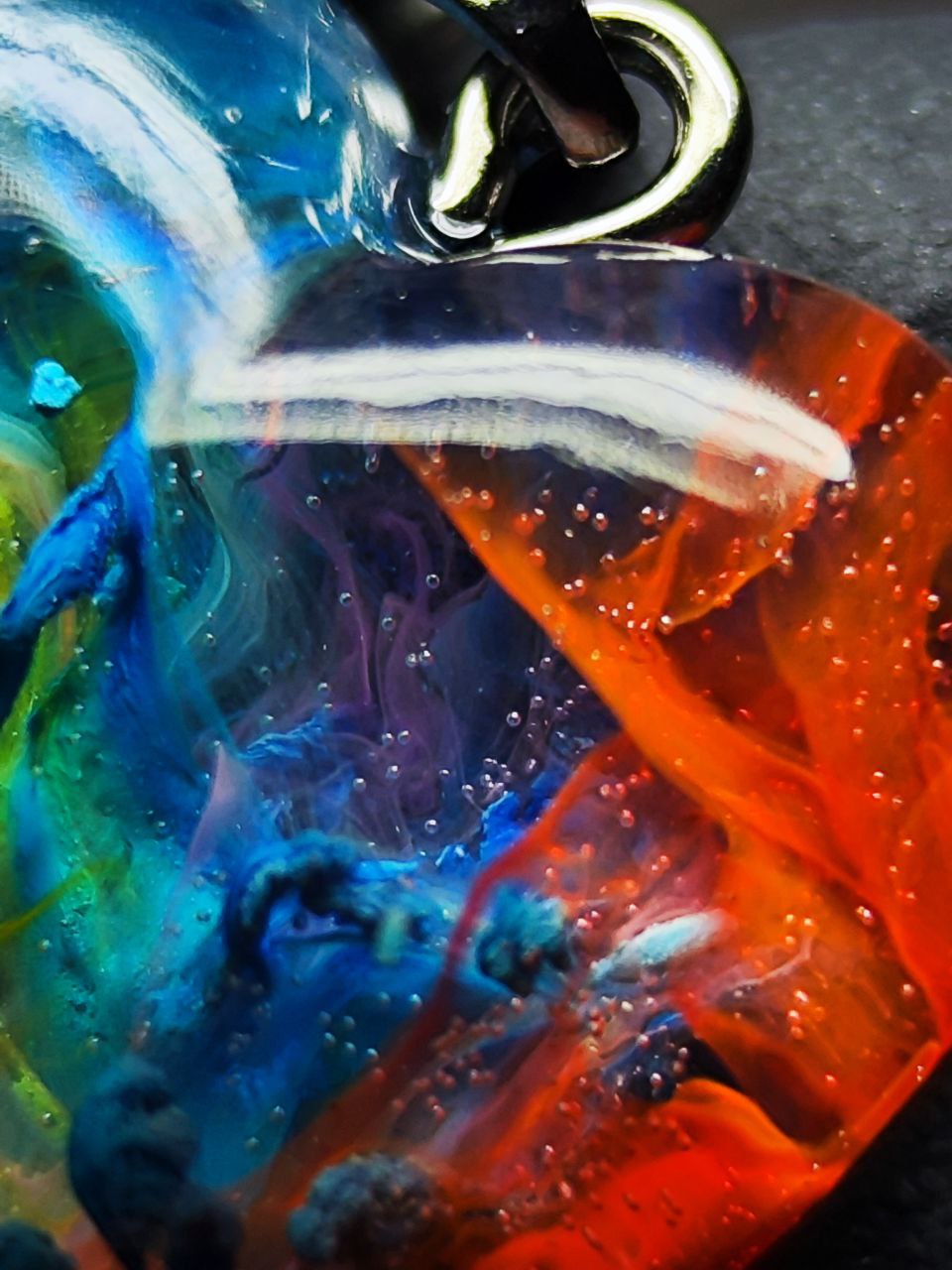 Magic jewelry space hearts made of epoxy resin and alcohol ink.