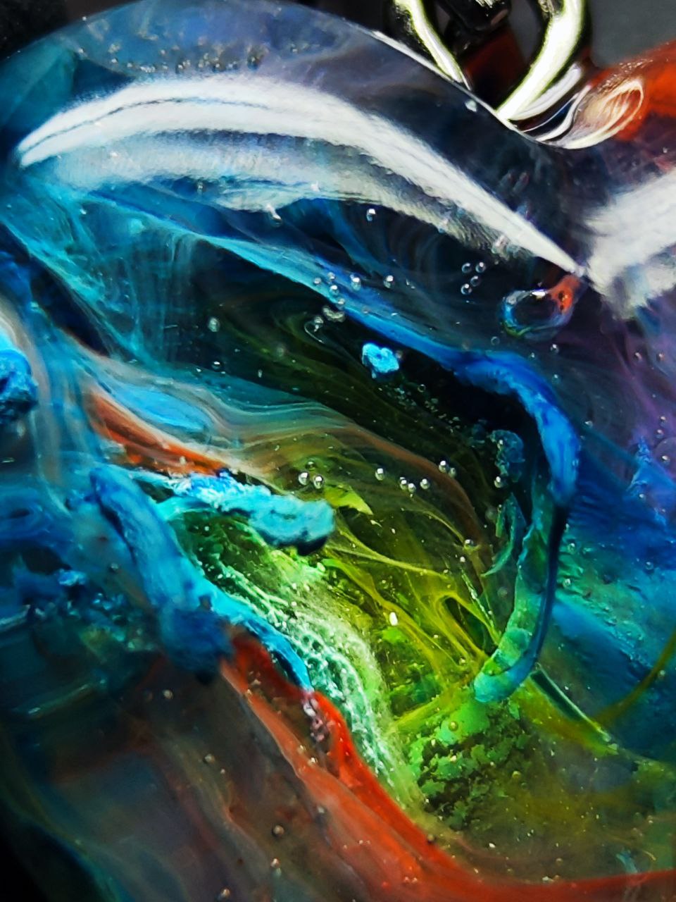 Magic jewelry space hearts made of epoxy resin and alcohol ink.