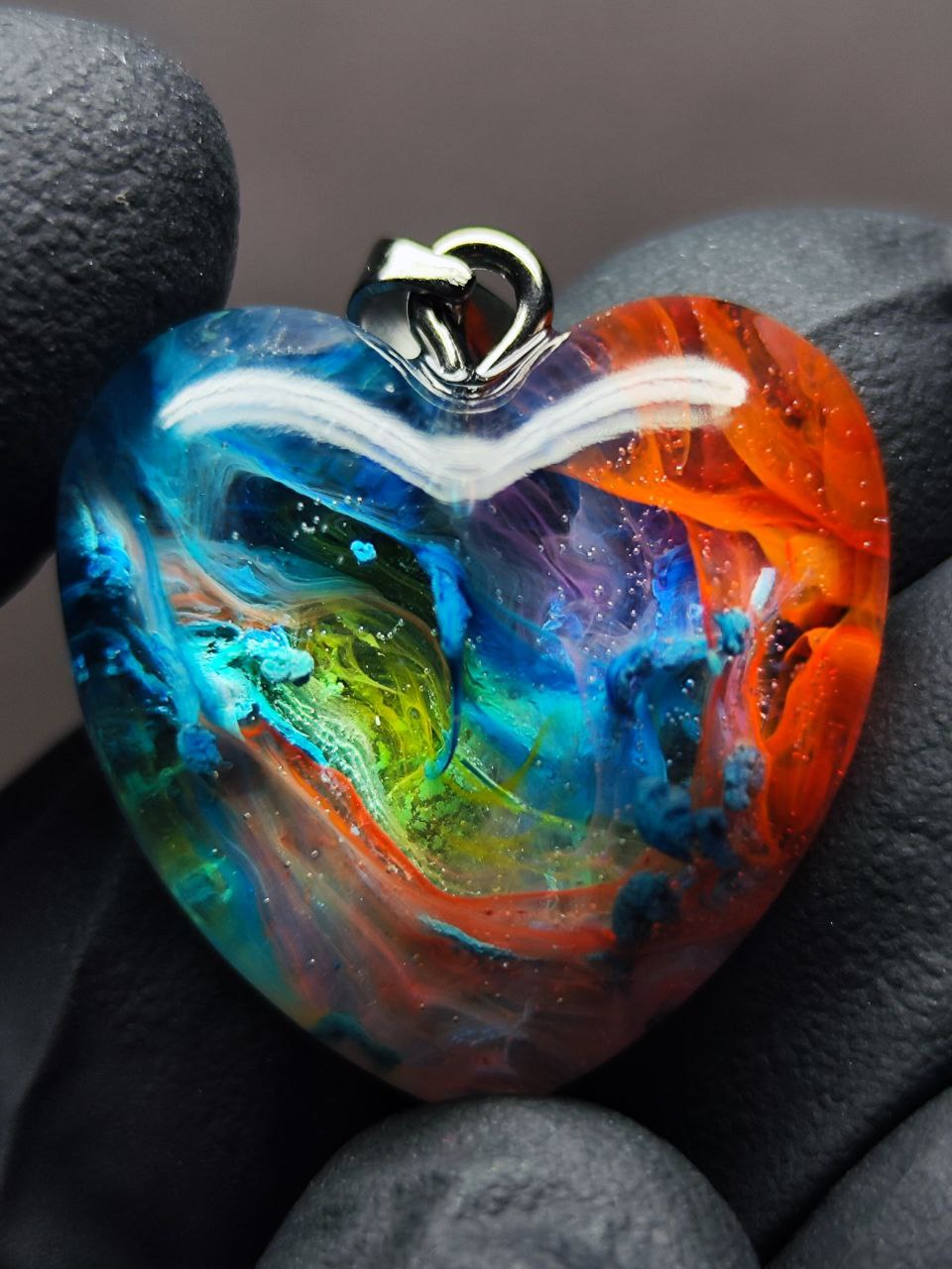 Magic jewelry space hearts made of epoxy resin and alcohol ink.