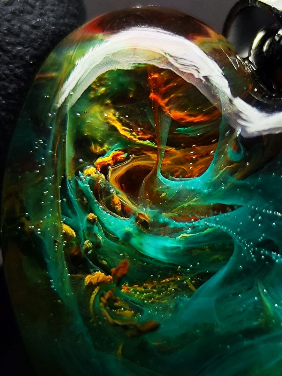 Magic jewelry space hearts made of epoxy resin and alcohol ink.