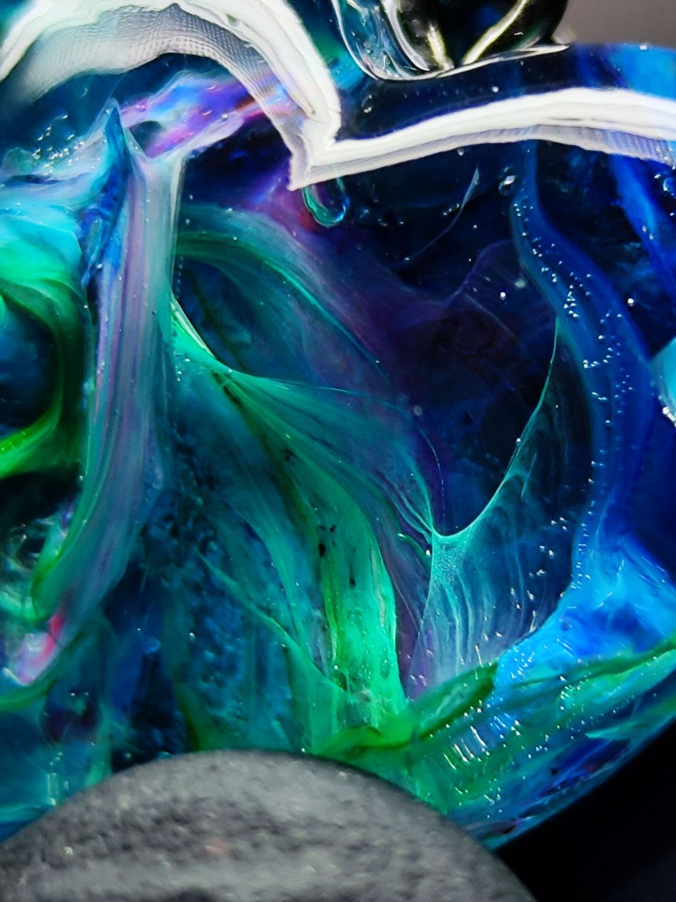 Magic jewelry space hearts made of epoxy resin and alcohol ink.