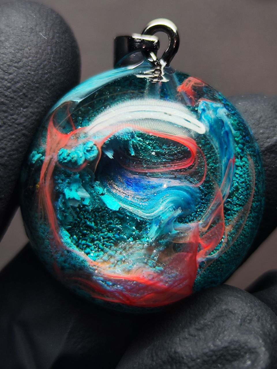 Magic jewelry space hearts made of epoxy resin and alcohol ink.