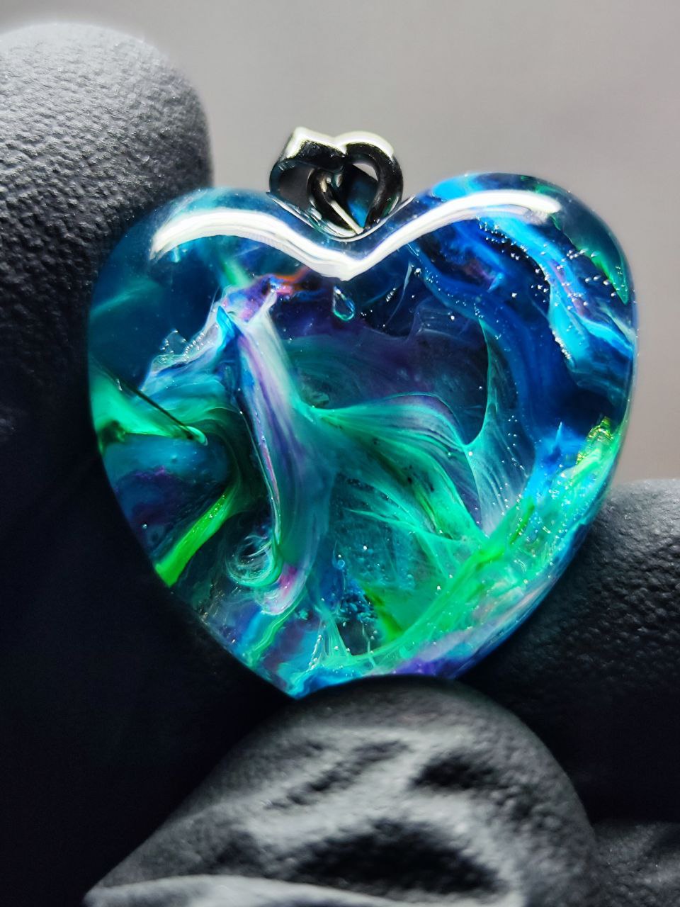 Magic jewelry space hearts made of epoxy resin and alcohol ink.