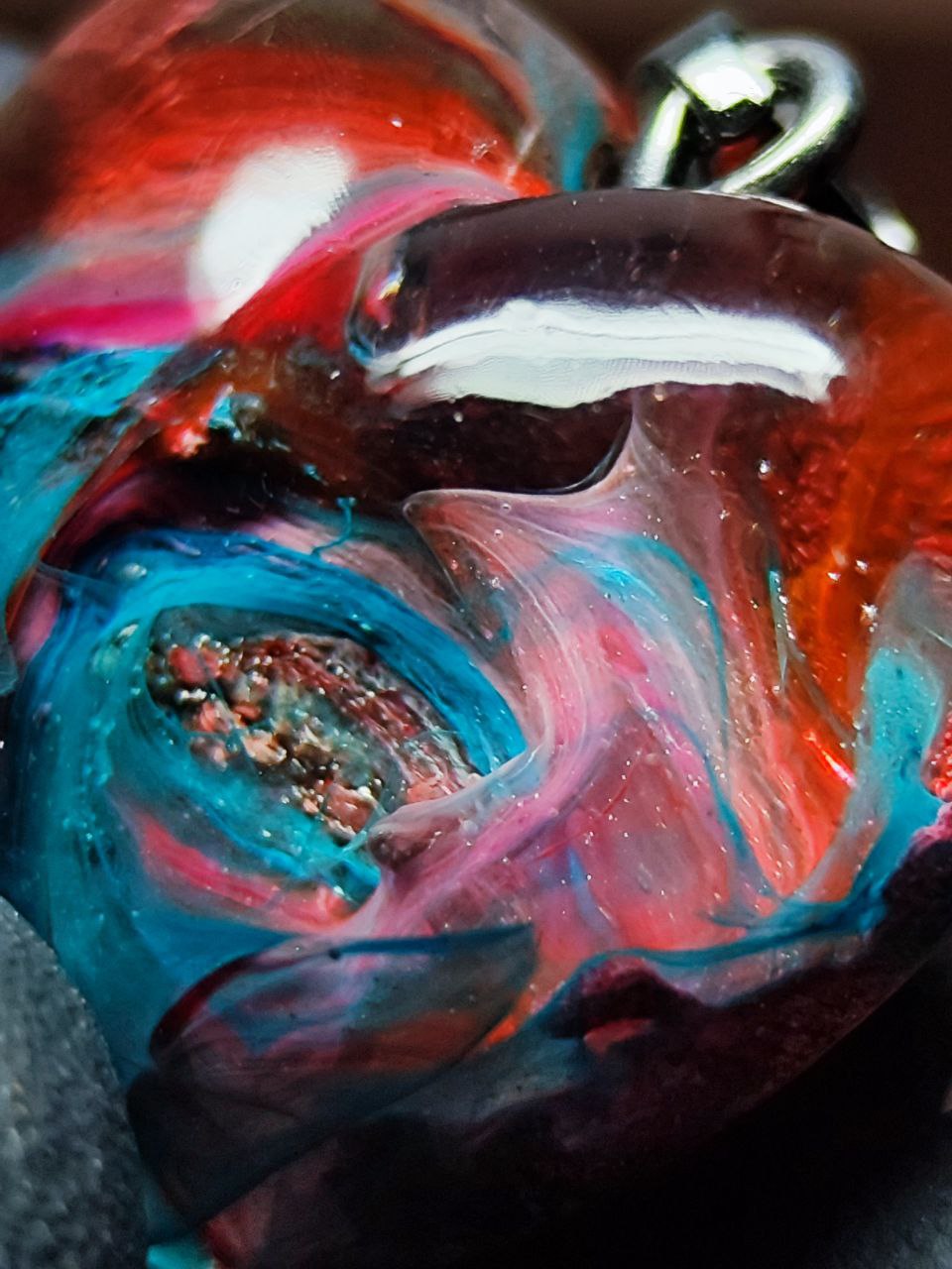 Magic jewelry space hearts made of epoxy resin and alcohol ink.