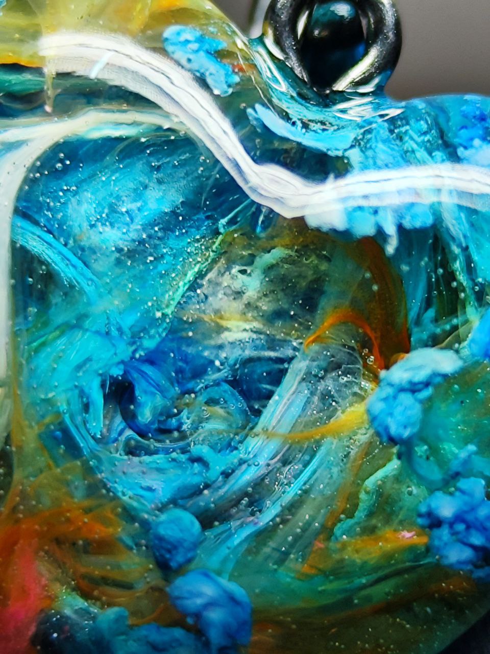 Magic jewelry space hearts made of epoxy resin and alcohol ink.