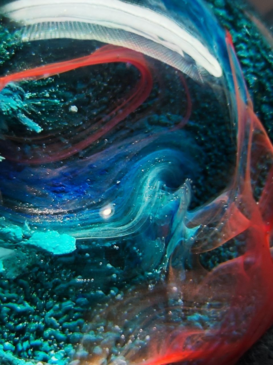 Magic jewelry space hearts made of epoxy resin and alcohol ink.