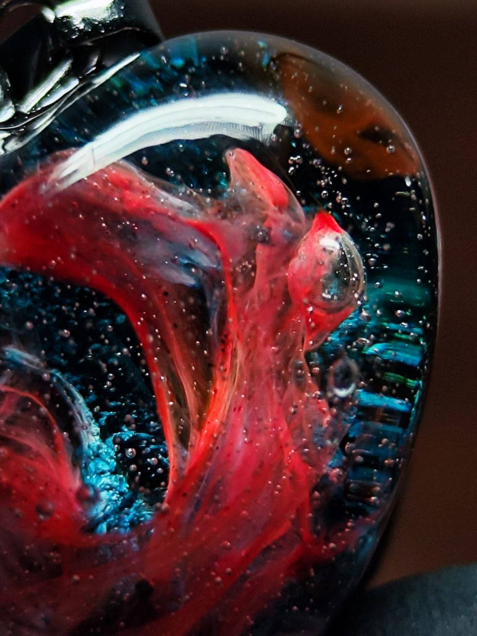 Magic jewelry space hearts made of epoxy resin and alcohol ink.