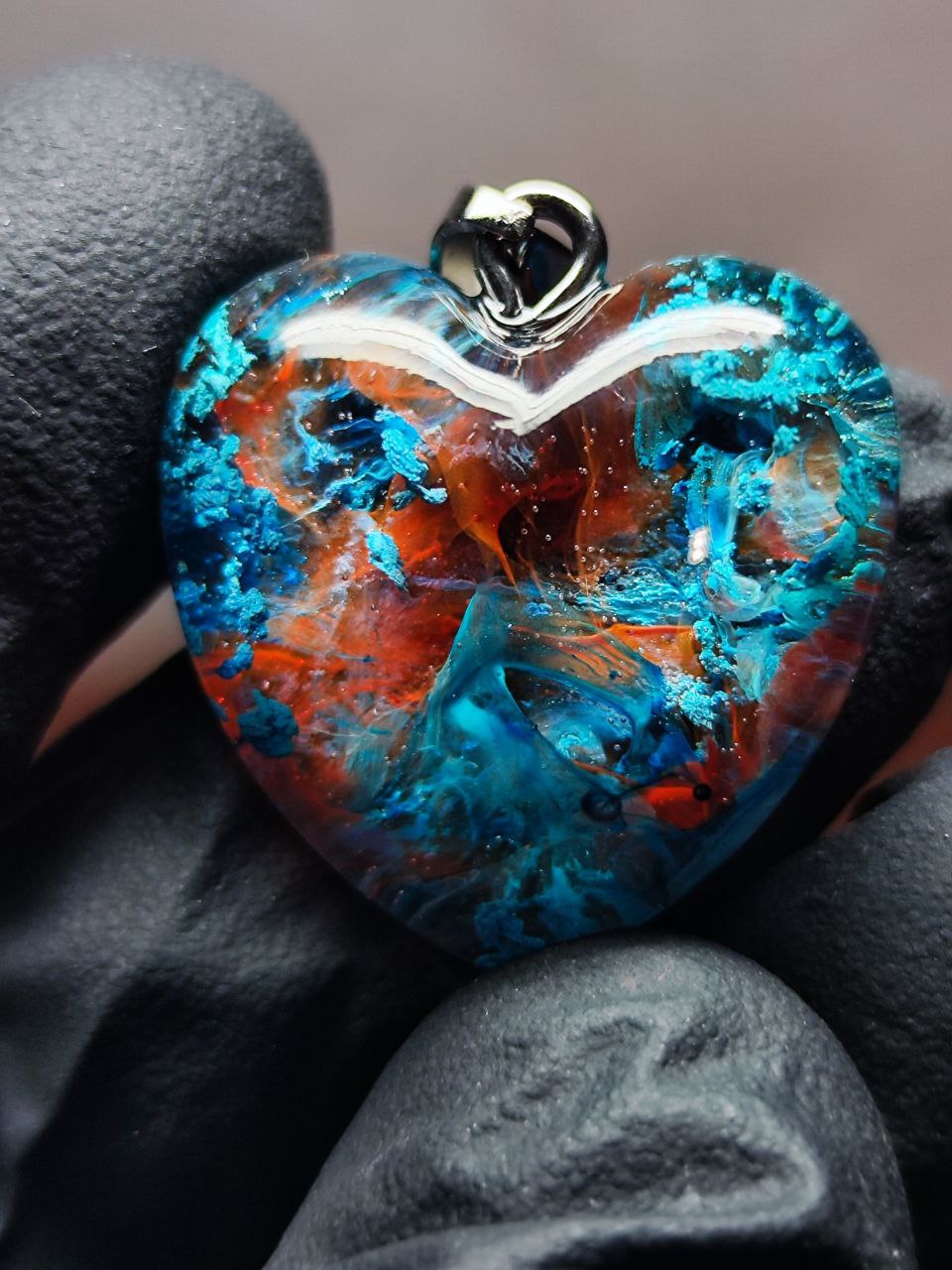 Magic jewelry space hearts made of epoxy resin and alcohol ink.