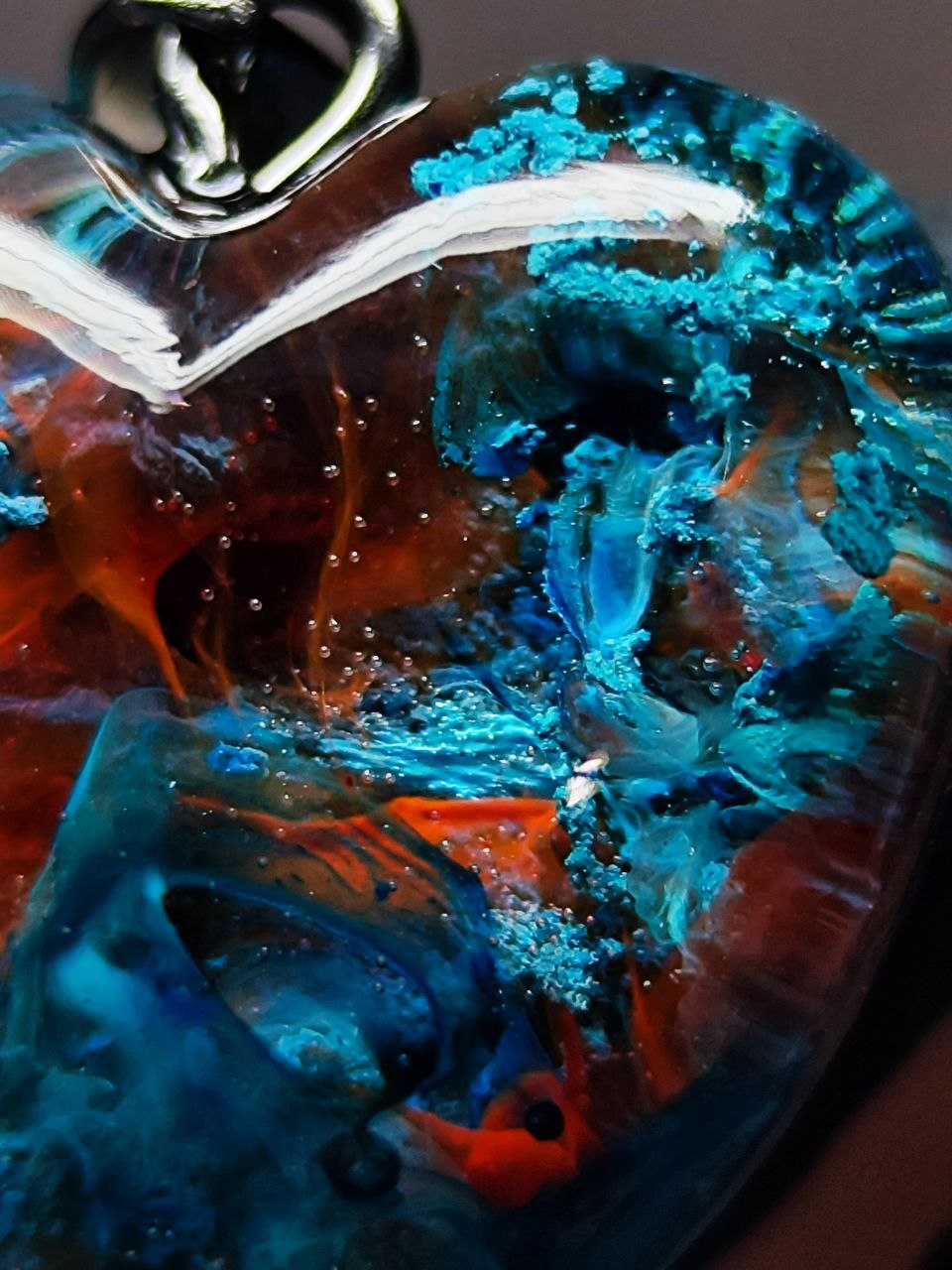 Magic jewelry space hearts made of epoxy resin and alcohol ink.