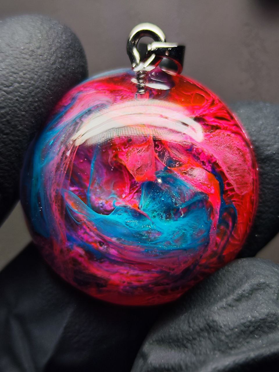 Magic jewelry space hearts made of epoxy resin and alcohol ink.