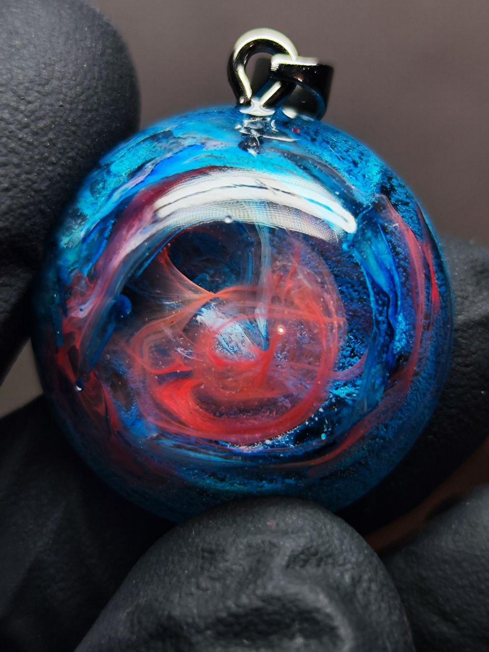 Magic jewelry space hearts made of epoxy resin and alcohol ink.